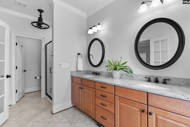 bathroom with ornamental molding, double vanity, a shower stall, tile patterned floors, and baseboards