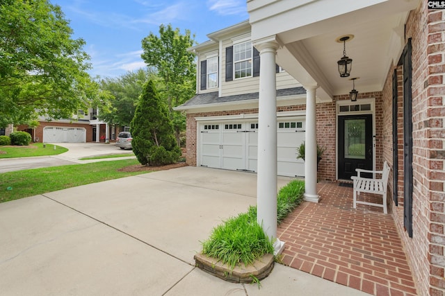 exterior space featuring driveway, brick siding, and a garage