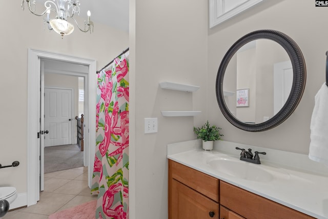 bathroom with tile patterned floors, vanity, a chandelier, toilet, and curtained shower