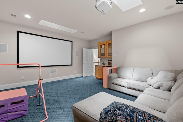 home theater room with a skylight, dark colored carpet, baseboards, and recessed lighting