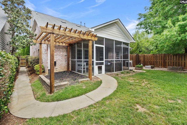 back of property featuring a sunroom, brick siding, and a pergola