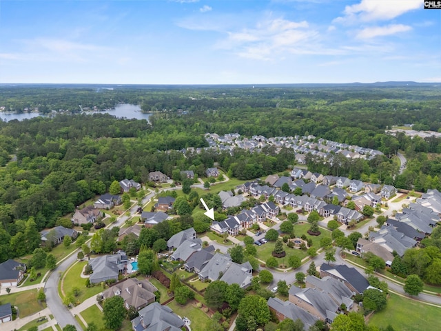 aerial overview of property's location featuring a forest, a large body of water, and nearby suburban area