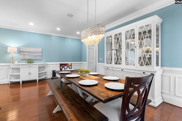 dining room with crown molding, a chandelier, a decorative wall, a wainscoted wall, and recessed lighting