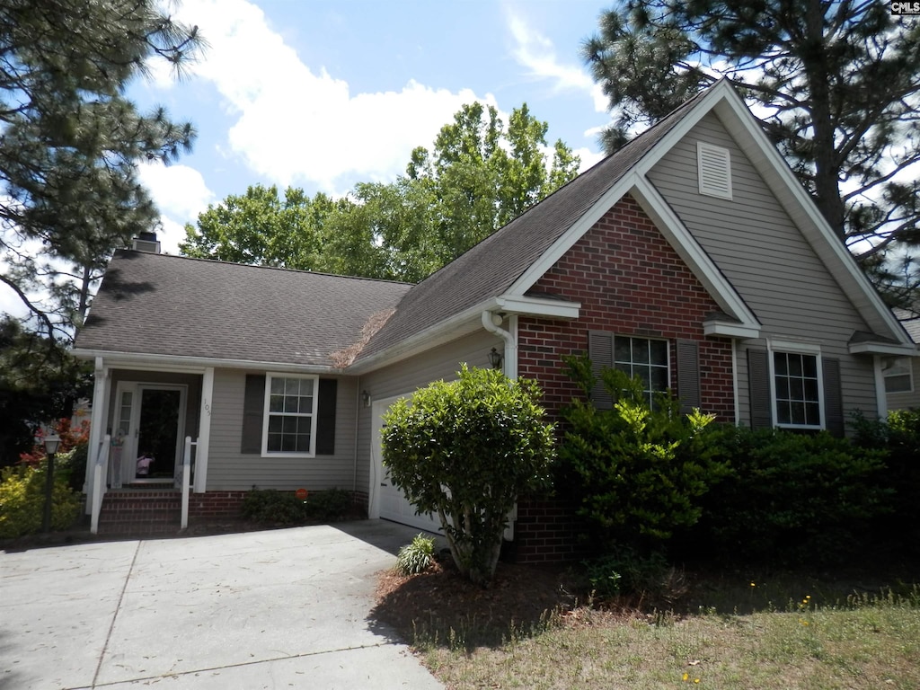 105 Applehill Ct, Columbia, SC 29229 - view of front facade featuring an attached garage, concrete driveway, a chimney, and roof with shingles