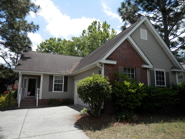 105 Applehill Ct, Columbia, SC 29229 - view of front facade featuring an attached garage, concrete driveway, a chimney, and roof with shingles