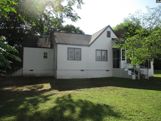 rear view of property with crawl space, a yard, a sunroom, and entry steps