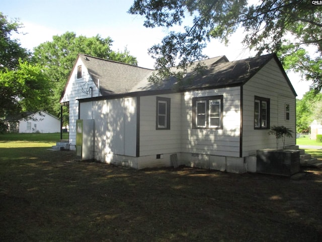 back of property featuring crawl space and roof with shingles
