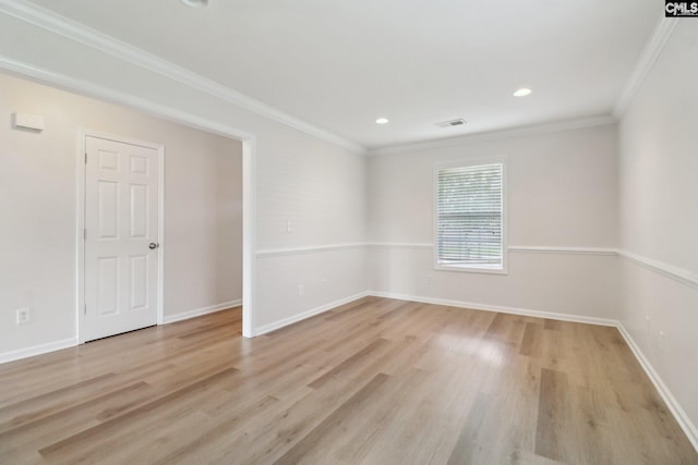 spare room with light wood finished floors, crown molding, baseboards, and recessed lighting
