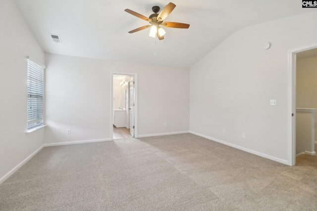 unfurnished room with a ceiling fan, lofted ceiling, light colored carpet, and baseboards