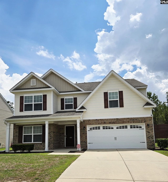 view of front of property with an attached garage, driveway, board and batten siding, brick siding, and a front lawn
