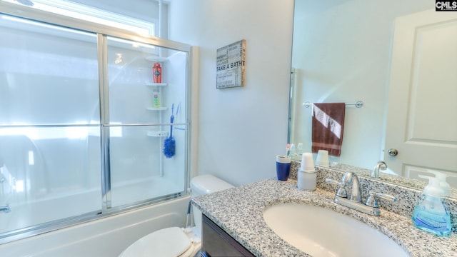 full bathroom with toilet, vanity, and combined bath / shower with glass door