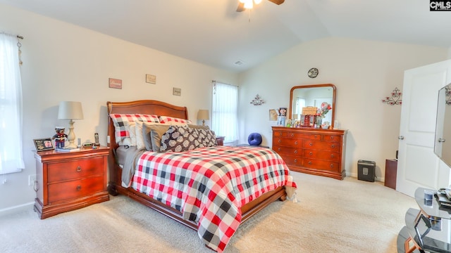 bedroom with vaulted ceiling, carpet, baseboards, and a ceiling fan