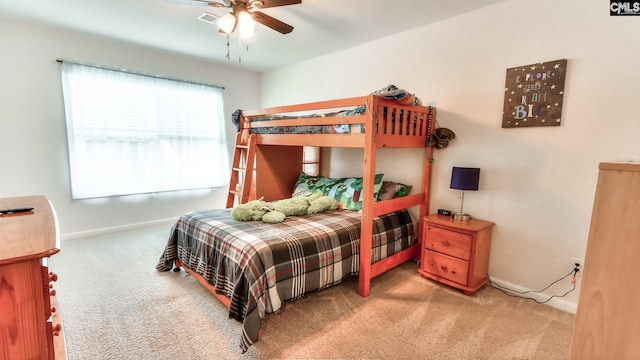 carpeted bedroom featuring baseboards and ceiling fan