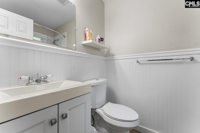 4306 Windemere Ave, Columbia, SC 29203 - full bath featuring toilet, wainscoting, vanity, and a shower