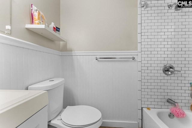 4306 Windemere Ave, Columbia, SC 29203 - bathroom featuring a wainscoted wall, toilet, vanity, and shower / bathtub combination
