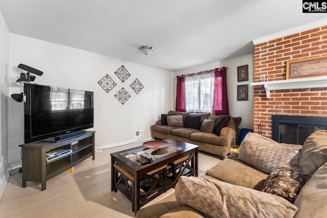 4306 Windemere Ave, Columbia, SC 29203 - living area with a textured ceiling, wood finished floors, a fireplace, and baseboards