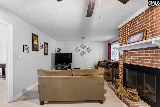 4306 Windemere Ave, Columbia, SC 29203 - living room featuring a ceiling fan, a textured ceiling, a brick fireplace, and light wood-type flooring