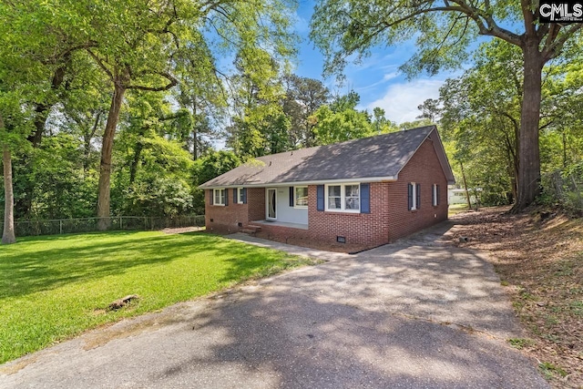 4306 Windemere Ave, Columbia, SC 29203 - ranch-style home with crawl space, brick siding, driveway, a shingled roof, and view of wooded area
