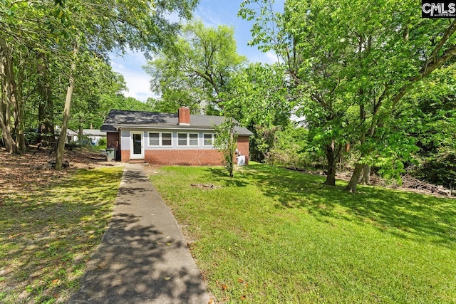 4306 Windemere Ave, Columbia, SC 29203 - view of front facade featuring brick siding, a front yard, and a chimney