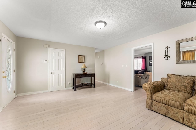 4306 Windemere Ave, Columbia, SC 29203 - living area featuring a textured ceiling, light wood finished floors, and baseboards