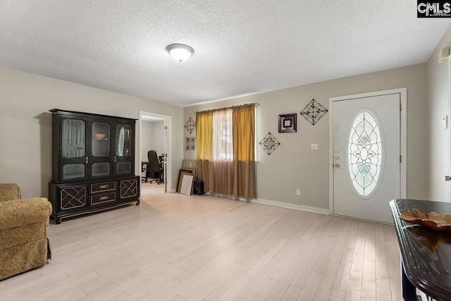 4306 Windemere Ave, Columbia, SC 29203 - entrance foyer featuring healthy amount of natural light, light wood-style flooring, a textured ceiling, and baseboards