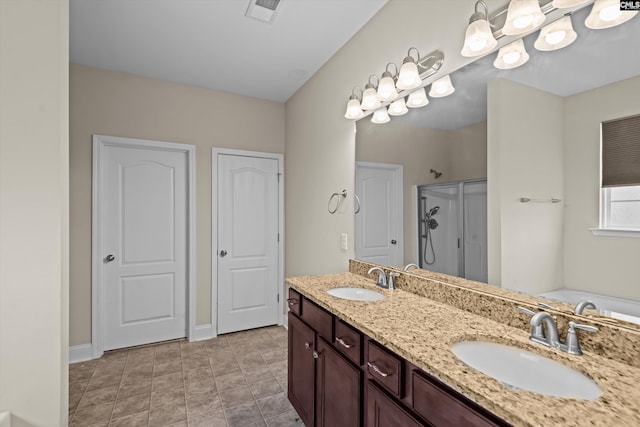 full bathroom featuring a stall shower, double vanity, and baseboards