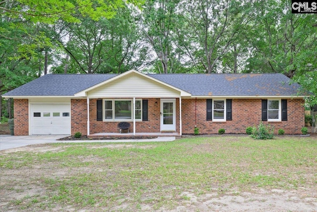 1045 Manchester Cir, Sumter, SC 29154 - ranch-style home featuring a garage, concrete driveway, a front lawn, brick siding, and a shingled roof