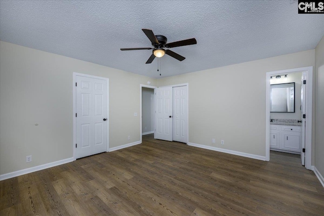 1045 Manchester Cir, Sumter, SC 29154 - unfurnished bedroom with dark wood finished floors, baseboards, connected bathroom, a textured ceiling, and a ceiling fan