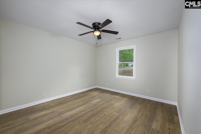 1045 Manchester Cir, Sumter, SC 29154 - empty room with dark wood finished floors, a ceiling fan, baseboards, and a textured ceiling