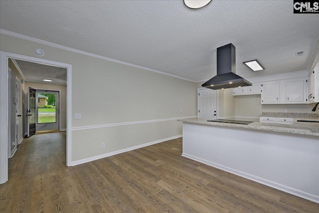 1045 Manchester Cir, Sumter, SC 29154 - kitchen featuring island exhaust hood, black electric stovetop, white cabinets, dark wood-style floors, and a textured ceiling