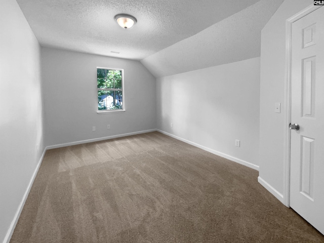 bonus room with a textured ceiling, carpet flooring, baseboards, and lofted ceiling