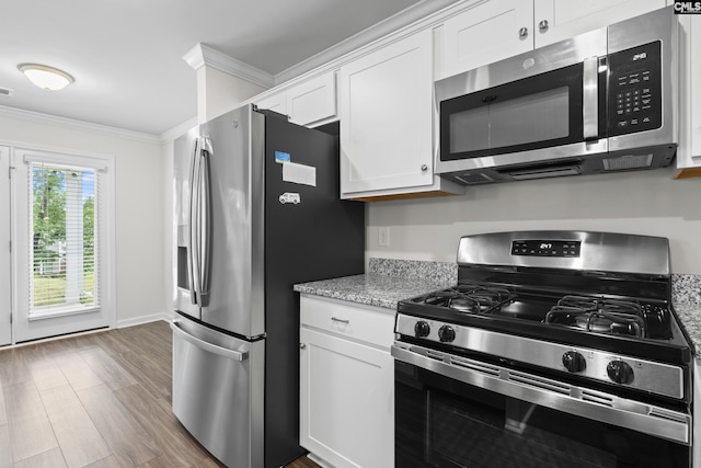2794 Prince Charles Ct, Columbia, SC 29209 - kitchen with stainless steel appliances, crown molding, white cabinets, wood finished floors, and light stone counters