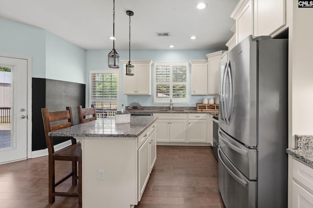 1307 Dusty Rd, Cope, SC 29038 - kitchen featuring freestanding refrigerator, a sink, a breakfast bar area, dark wood-style flooring, and recessed lighting