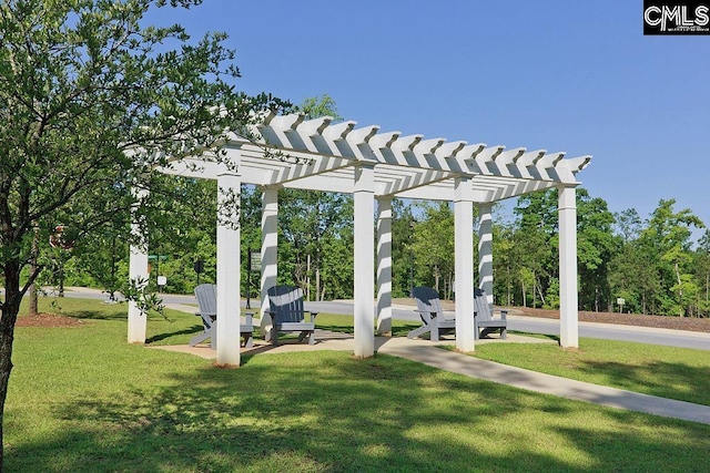 view of green lawn with a pergola