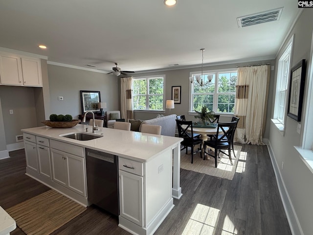 kitchen with stainless steel dishwasher, a sink, white cabinets, light countertops, and a kitchen island with sink