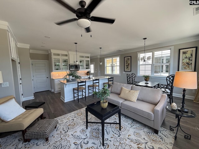 1016 Manarola Rd, Lexington, SC 29072 - living area featuring crown molding, dark wood finished floors, ceiling fan, baseboards, and a chandelier