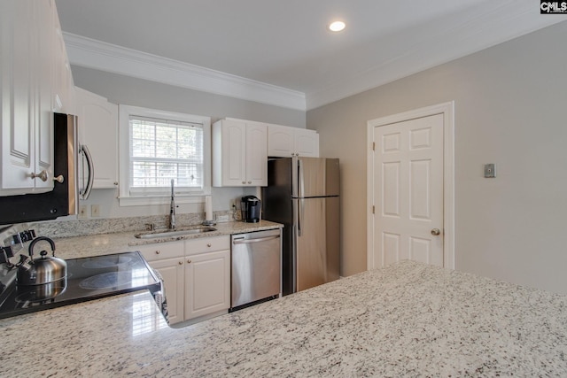1029 Maxcy St, Columbia, SC 29201 - kitchen with appliances with stainless steel finishes, a sink, ornamental molding, white cabinets, and light stone countertops