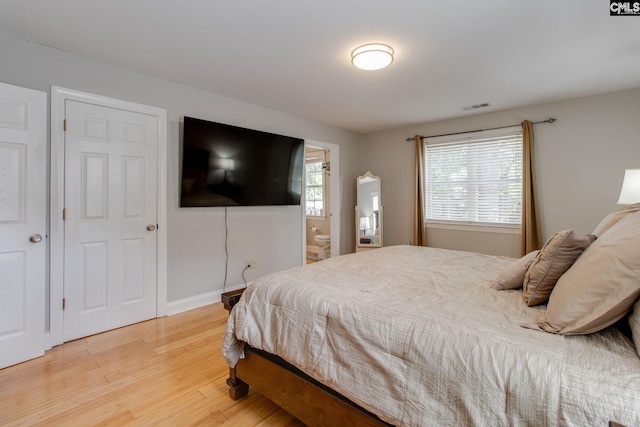 1029 Maxcy St, Columbia, SC 29201 - bedroom with light wood finished floors, baseboards, and ensuite bath