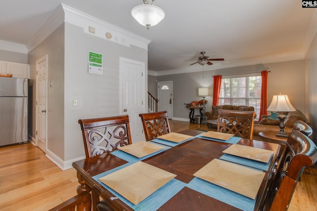 1029 Maxcy St, Columbia, SC 29201 - dining room featuring crown molding, baseboards, light wood-style flooring, a ceiling fan, and stairway
