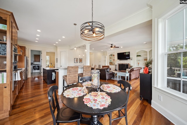 3011 River Vista Way, Mount Pleasant, SC 29466 - dining area with ceiling fan, a fireplace, washer / dryer, dark wood-style flooring, and ornamental molding