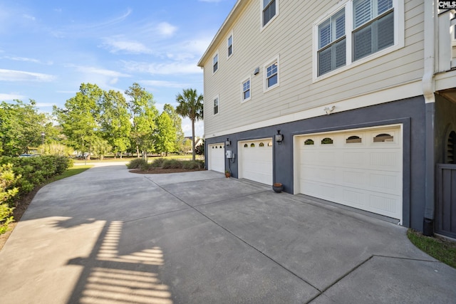 3011 River Vista Way, Mount Pleasant, SC 29466 - view of property exterior featuring concrete driveway, an attached garage, and stucco siding