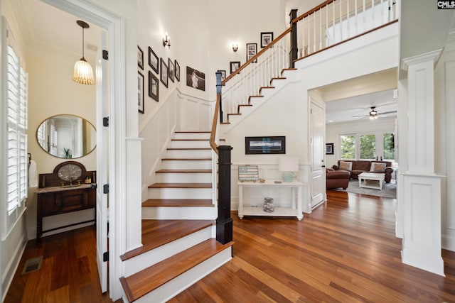 3011 River Vista Way, Mount Pleasant, SC 29466 - staircase with wood finished floors, crown molding, ceiling fan, decorative columns, and a towering ceiling