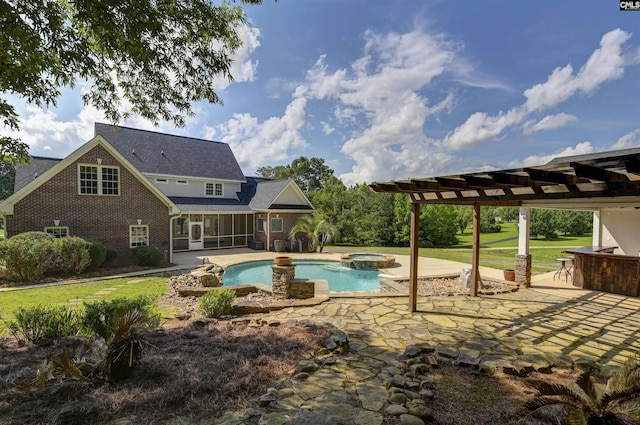 view of pool featuring a patio, a pool with connected hot tub, a yard, and a pergola