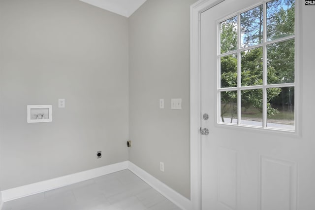 laundry area with hookup for an electric dryer, plenty of natural light, baseboards, and hookup for a washing machine