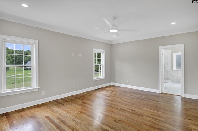 unfurnished room with plenty of natural light, ceiling fan, wood finished floors, baseboards, and recessed lighting