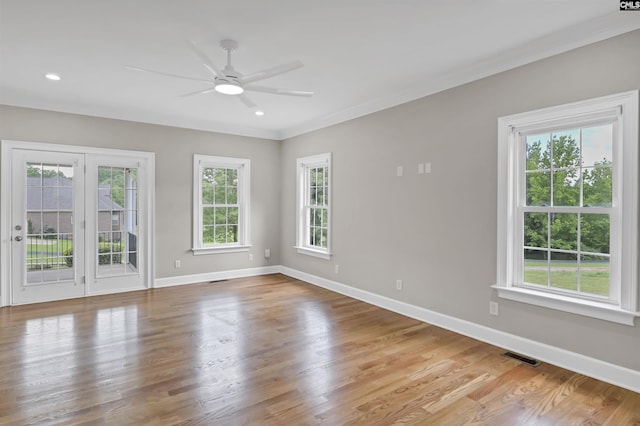 spare room featuring plenty of natural light, a ceiling fan, baseboards, ornamental molding, and recessed lighting