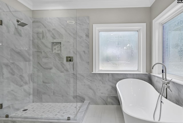 bathroom featuring a stall shower, a freestanding tub, and crown molding