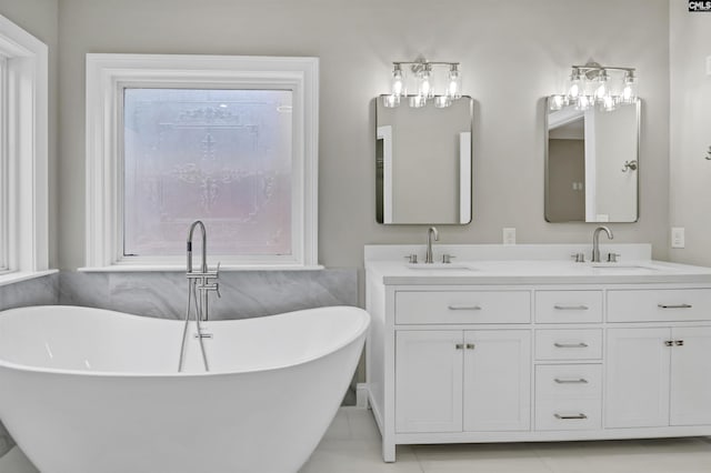 full bathroom with double vanity, a soaking tub, and tile patterned floors