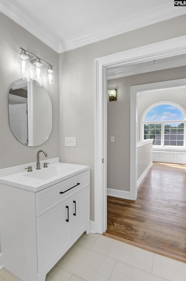 bathroom featuring ornamental molding, tile patterned flooring, vanity, and baseboards