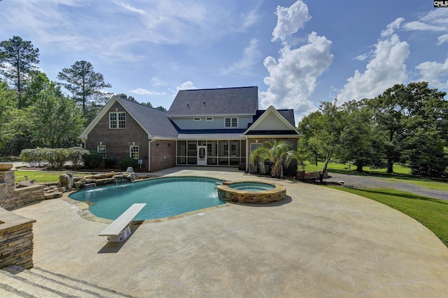 view of swimming pool featuring a sunroom, a patio, and a pool with connected hot tub